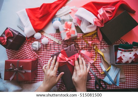 Gift wrapping. Woman packs gifts.