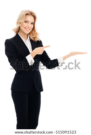 Happy smiling young businesswoman, showing something, some product or blank copyspace area for advertise slogan or text message, on white background. Caucasian blond model in business success concept.