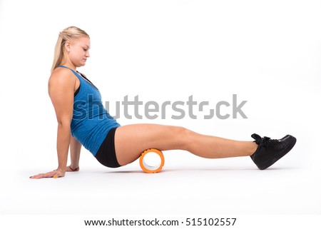 Health concept. Picture of fitness woman training with orange massage device isolated on white background in studio.