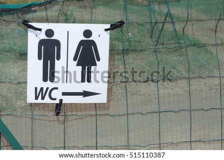 Restroom signs with female and male symbol and arrow direction
