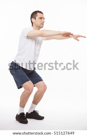 Young man doing exercises, white background