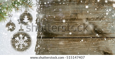 christmas card or new year background made of xmas symbols handwritten on snow with fir-tree branches and wooden table