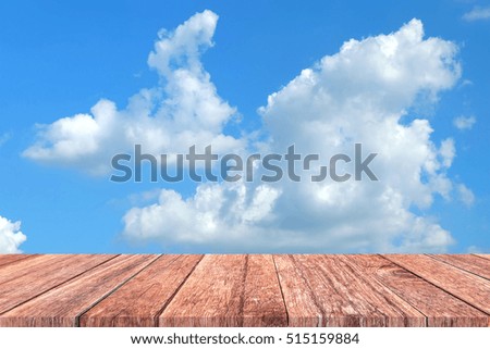Wooden floor with cloud and blue sky background.