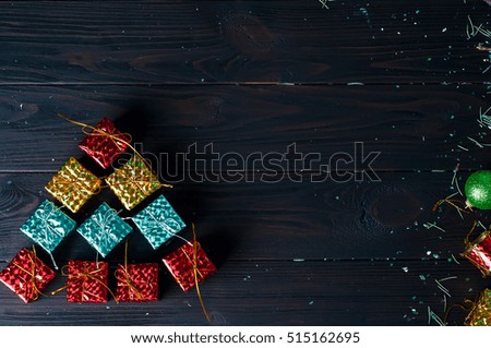 Christmas tree made of colorful box on a black background. Space for text