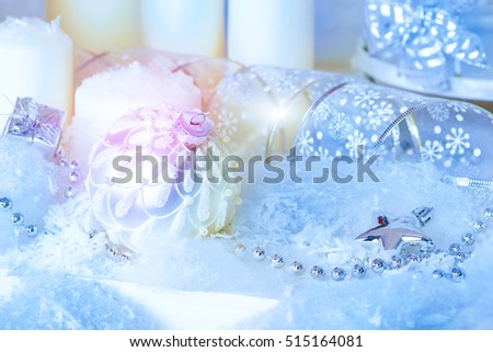 Christmas background: beautiful christmas decorations and candles in the snow. 