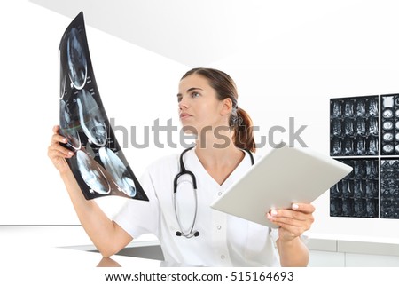 Radiologist woman checking x ray, with tablet, medical and radiology concept