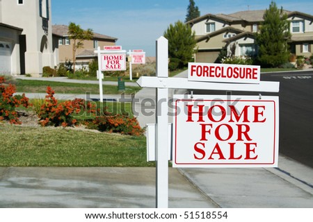 Row of Foreclosure Home For Sale Real Estate Signs in Front of Houses.