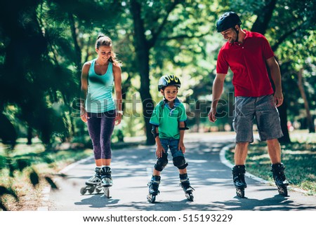 Cheerful family roller skating in park Royalty-Free Stock Photo #515193229