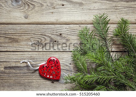 Background with fir branches and red Christmas decorations on old wooden boards. Space for text. Top view.

