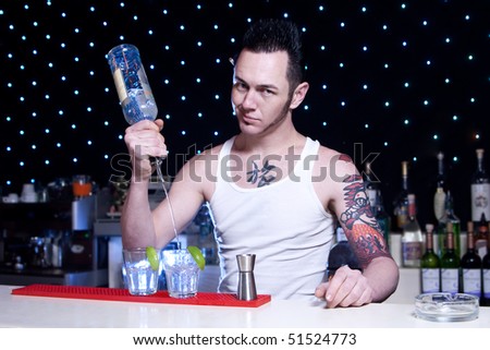 bartender is smiling and looking at the camera Royalty-Free Stock Photo #51524773