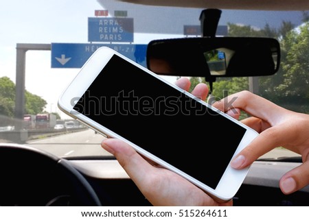 woman hand hold and touch screen smartphone, tablet,cellphone on city traffic in morning background.