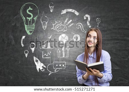 Nerdy girl with a book is standing near blackboard with dollar light bulb and business sketches on it. Concept of business education