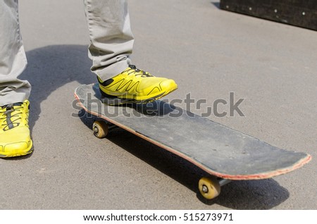 Young man with skateboard in the park