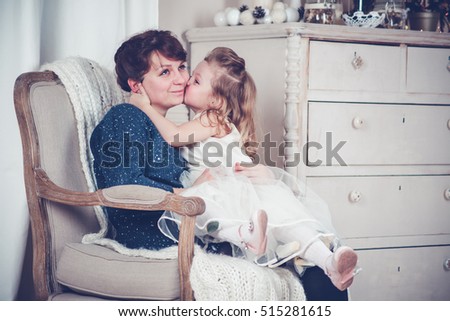 Mother and daughter in home interior