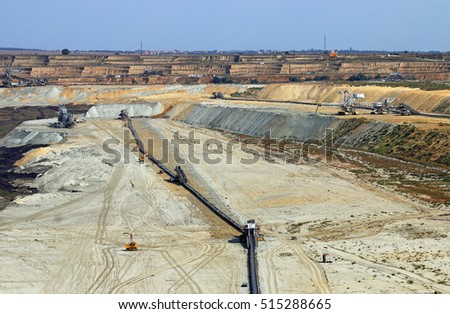 open pit coal mine with heavy machinery and excavators