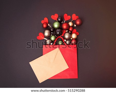 Shopping bag and christmas gifts on with hearts on grey background