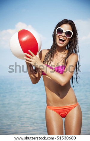 young female at the beach playing ball