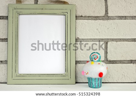 Christmas and New Year background. Empty picture frame, cupcake with with copy space blank tag on white background. Copy space image. Scandinavian style home interior decoration