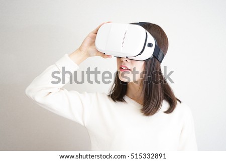 Young attractive Japanese woman using VR-headset glasses