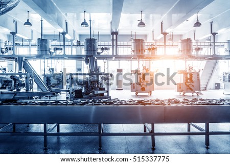 Automatic production line in the factory packing workshop, blue tint map. Royalty-Free Stock Photo #515337775