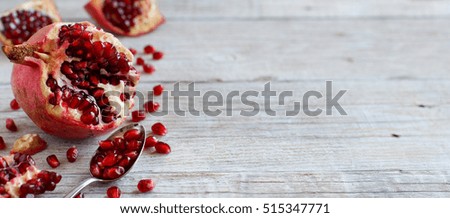 Open fresh ripe pomegranates on wooden background