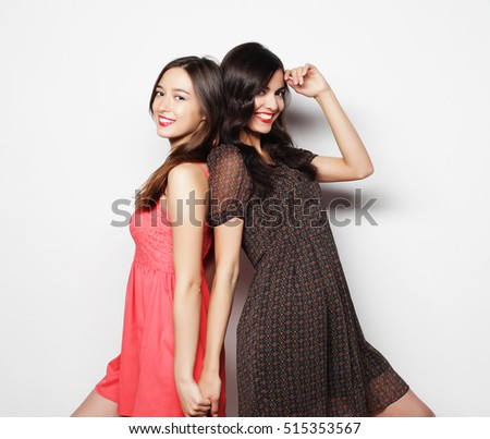 lifestyle and people concept: Two young girl friends standing to
