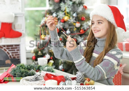 Girl making Christmas decoration