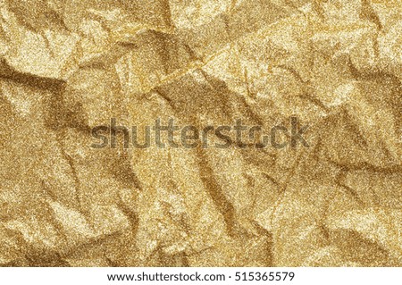 Gold wrinkled paper texture abstract background.