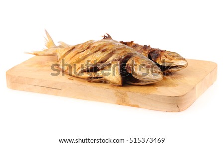Grilled fishes on chopping block isolated on white background