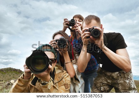 Group of friends photographers taking photo together