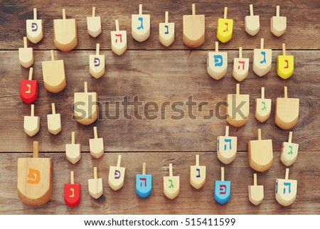 Image of jewish holiday Hanukkah with wooden dreidels colection (spinning top) on the table