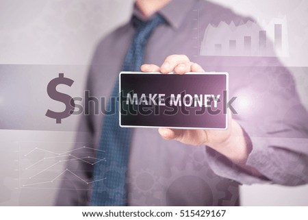 Close-Up Businessman Holding A Smartphone With The Text "Make Money" Business concept. Internet concept.