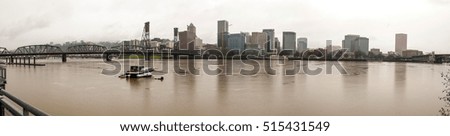 Panoramic view of the Portland skyline with rain and a boat