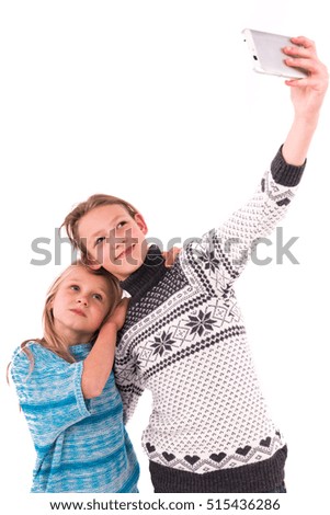 Two teen girls make selfie on a white background