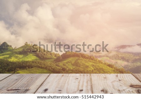 Empty top of wooden table and view of sunset or sunrise background