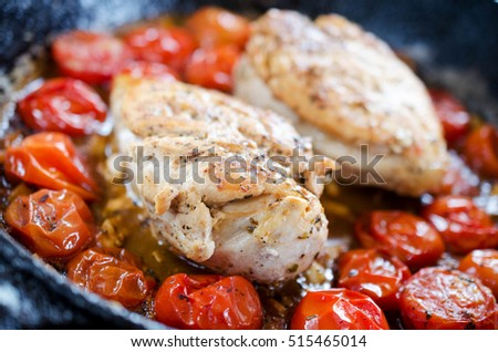 Close up of Fried chicken fillet with garnish of tomato Royalty-Free Stock Photo #515465014