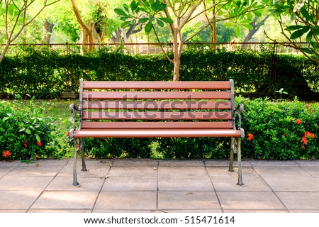 Wooden bench in the city park Royalty-Free Stock Photo #515471614