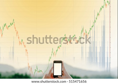 Stock exchange market trading graph over the screen of telephone laptop on hand the trading graph background, business marketing trade concept
