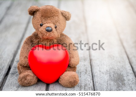 Brown Bear and Red Heart with old wood background for take care your love