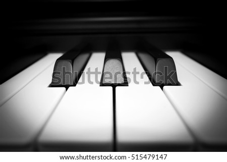 Closeup piano key. Art and abstract background. Music instrument. Front view with dark vignette. Black and white theme.