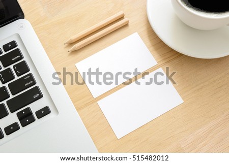 business card mockup with laptop and coffee cup on wooden table