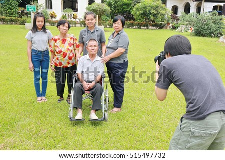 photographer take photo Asian family outdoor. 