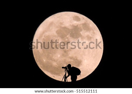 Silhouettes Photographer shooting pictures at night Super full moon.