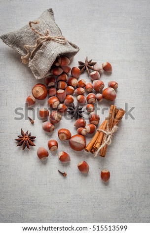 Christmas decoration. Hazelnuts with cinnamon sticks and star anise. top view
