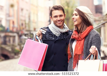 Picture showing young couple with shopping bags 