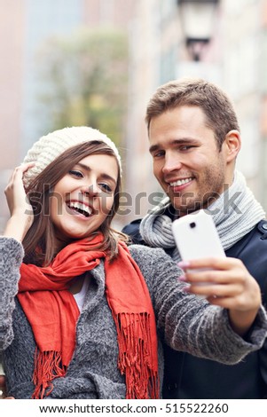 Picture showing young couple taking selfie in the city