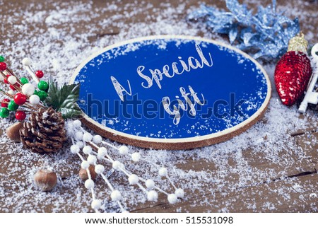 A Special Gift Written In Chalk On Blue Chalkboard Holiday Sign Background With Snow And Decorations.