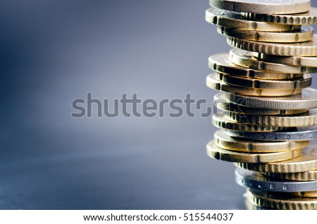 Euro money. Coins are isolated on a dark background. Currency of Europe. Balance of money. Building from coins. 
