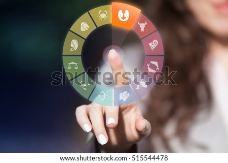 Zodiac signs on touch screen. Woman choosing Gemini horoscope symbol.
