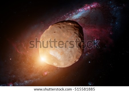 Phobos is the larger and inner of the two natural satellites of Mars, the other being Deimos. Retouched image. Elements of this image furnished by NASA. Royalty-Free Stock Photo #515581885